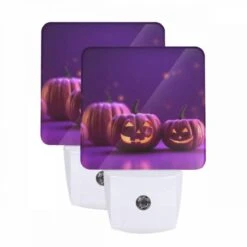 Night Light Set Of 2, Two Pumpkins With Faces Drawn On Them Sit On A Purple Background.
