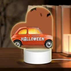Love Acrylic Night Light, A Small Orange Car With A Happy Halloween Sign On The Side.