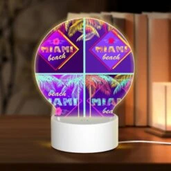 Round Acrylic Night Light, Four Different Colored Images Of Palm Trees And The Word "Miami Beach" On Them.
