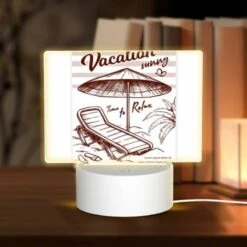 Rectangular Acrylic Night Light, A Beach Umbrella Is Open And Shading A Lounge Chair.