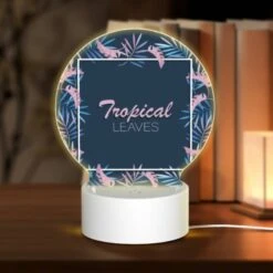 Round Acrylic Night Light, A Tropical Leaves Design With A Pink And Blue Color Scheme.