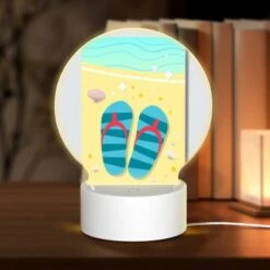 Round Acrylic Night Light, A Pair Of Blue And Red Flip Flops Are Placed On A Sandy Beach.