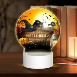 Round Acrylic Night Light, A Halloween Poster With A Witch's Hat And A House In The Background.