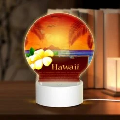 Round Acrylic Night Light, A Sign With A Picture Of A Flower And The Word Hawaii On It.