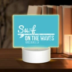Rectangular Acrylic Night Light, A Blue Sign That Says "Surf On The Waves" With A Picture Of A Surfboard.