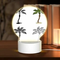 Round Acrylic Night Light, Four Different Types Of Palm Trees Are Shown In Silhouette.