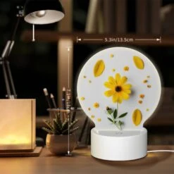 Round Acrylic Night Light, A Yellow Flower With Yellow Petals And Green Leaves Is Placed On A White Surface. 7 Round Acrylic Night Light, A Yellow Flower With Yellow Petals And Green Leaves Is Placed On A White Surface. -Pattern Night Light fbbe136bdeb108b9a6d06d841ec10da2aaadac76